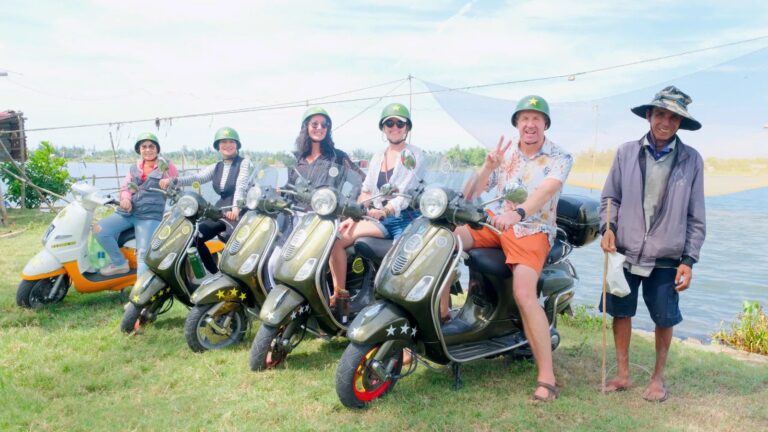 Guests with vintage Vespas on the countryside tour near Hoi An